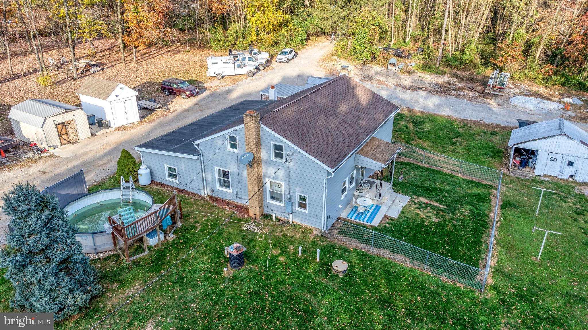 an aerial view of a house with garden space and street view