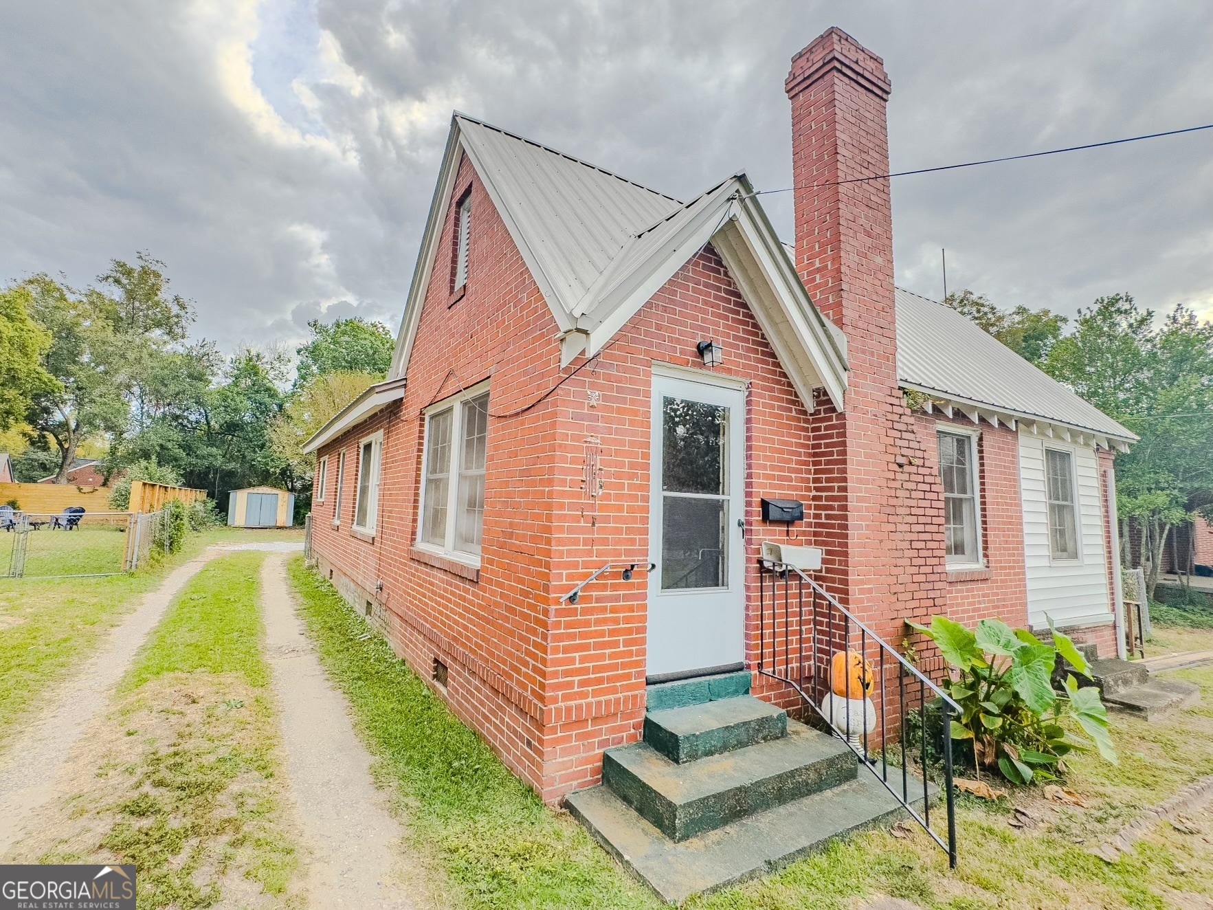 a front view of a house with a garden