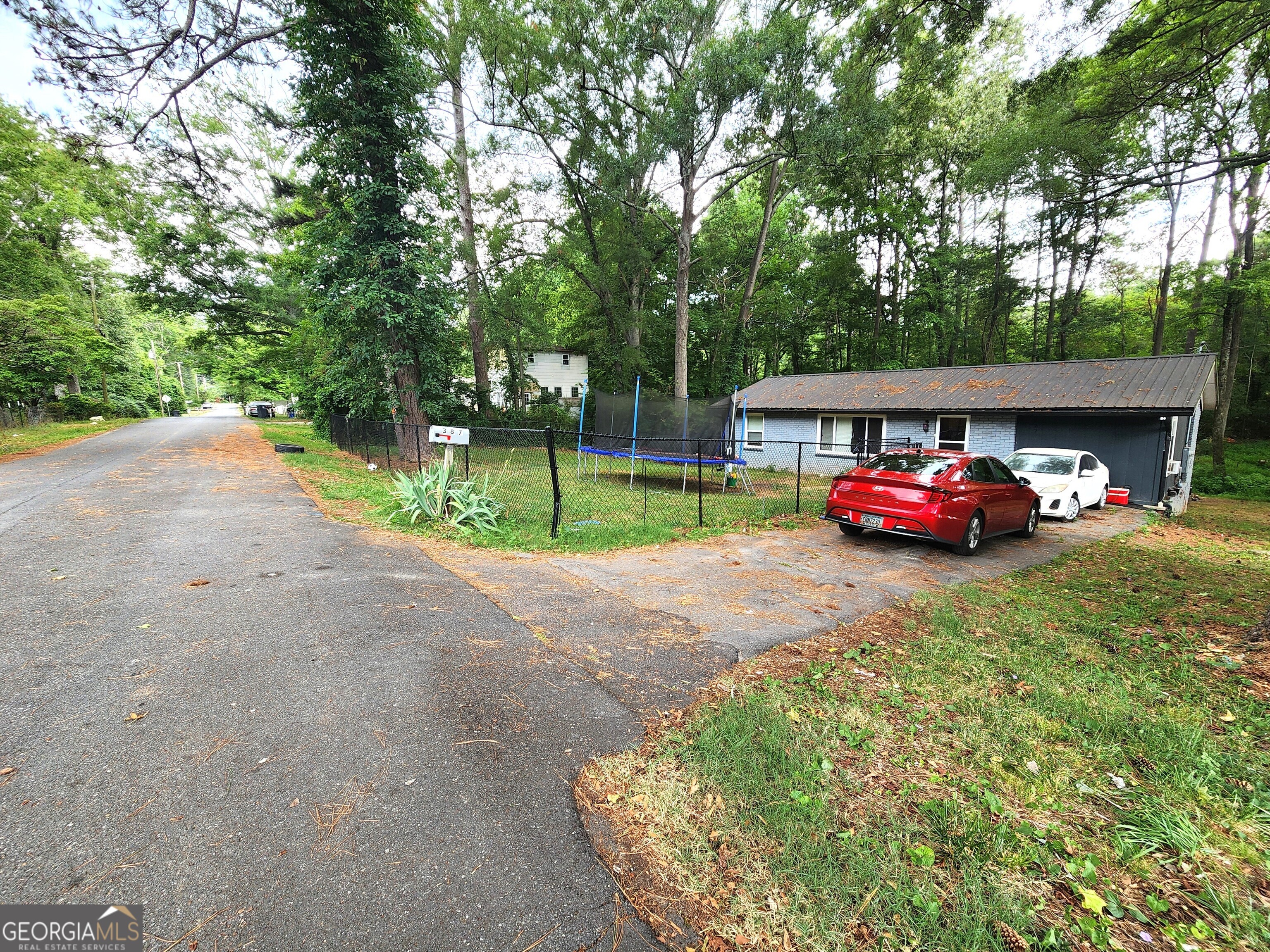 a car parked in front of a house with small garden