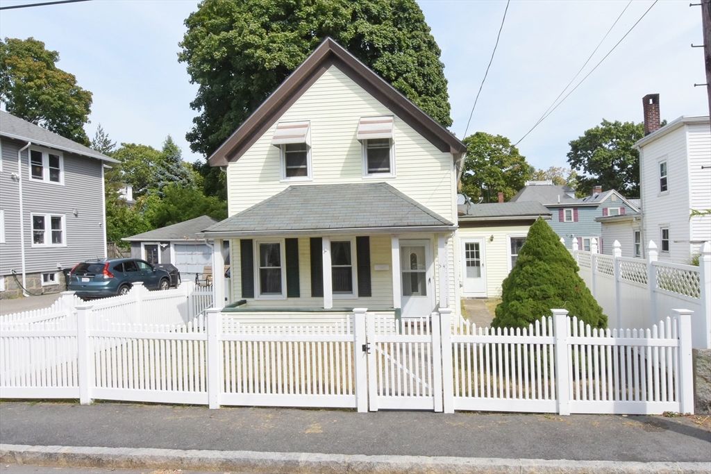 a front view of a house with a fence