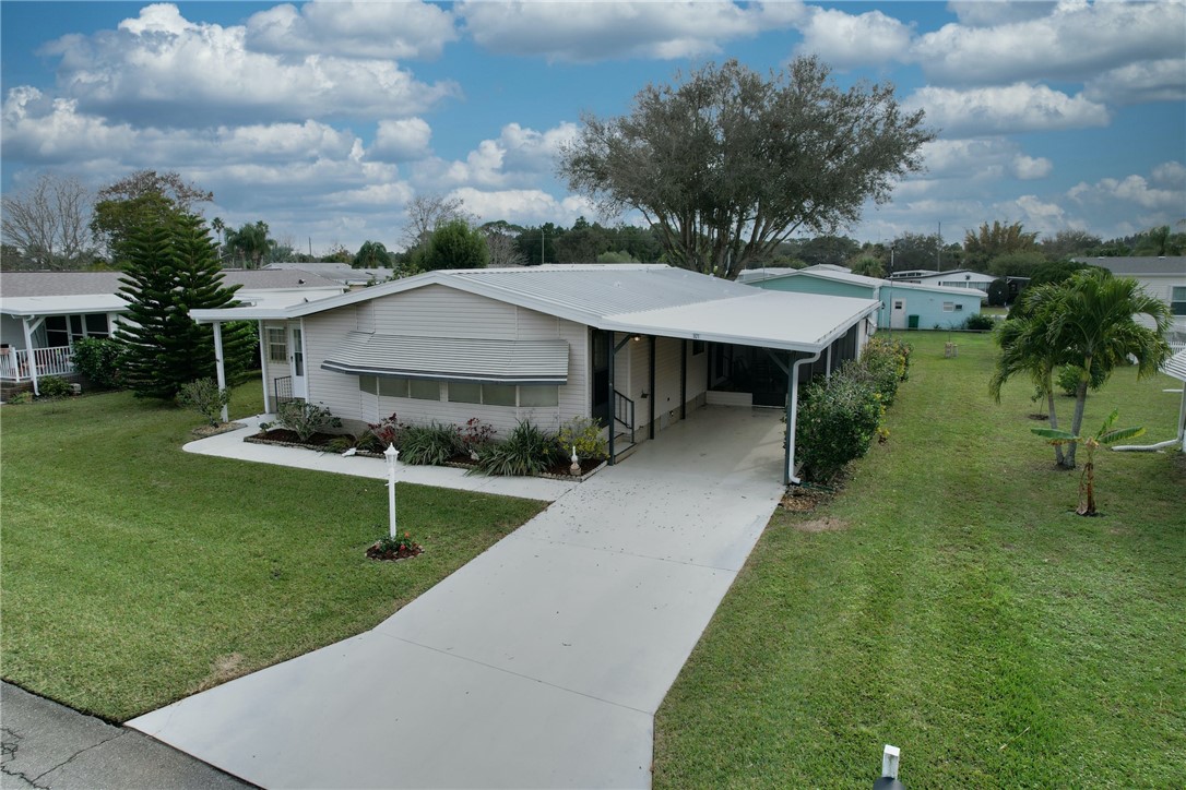 a aerial view of a house with a yard table and chairs