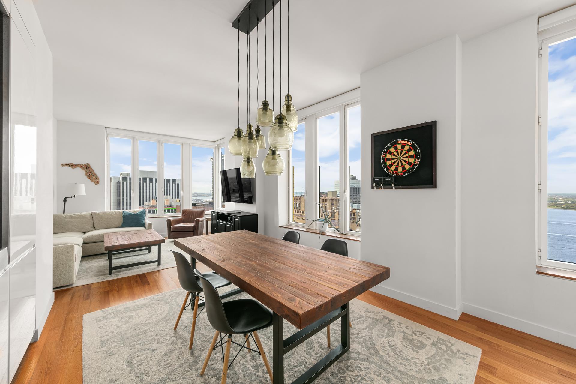 a view of a dining room with furniture and wooden floor