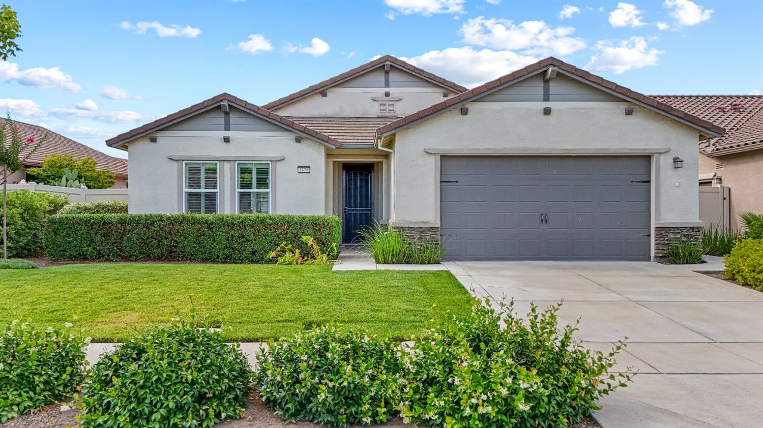 a front view of a house with a yard and garage