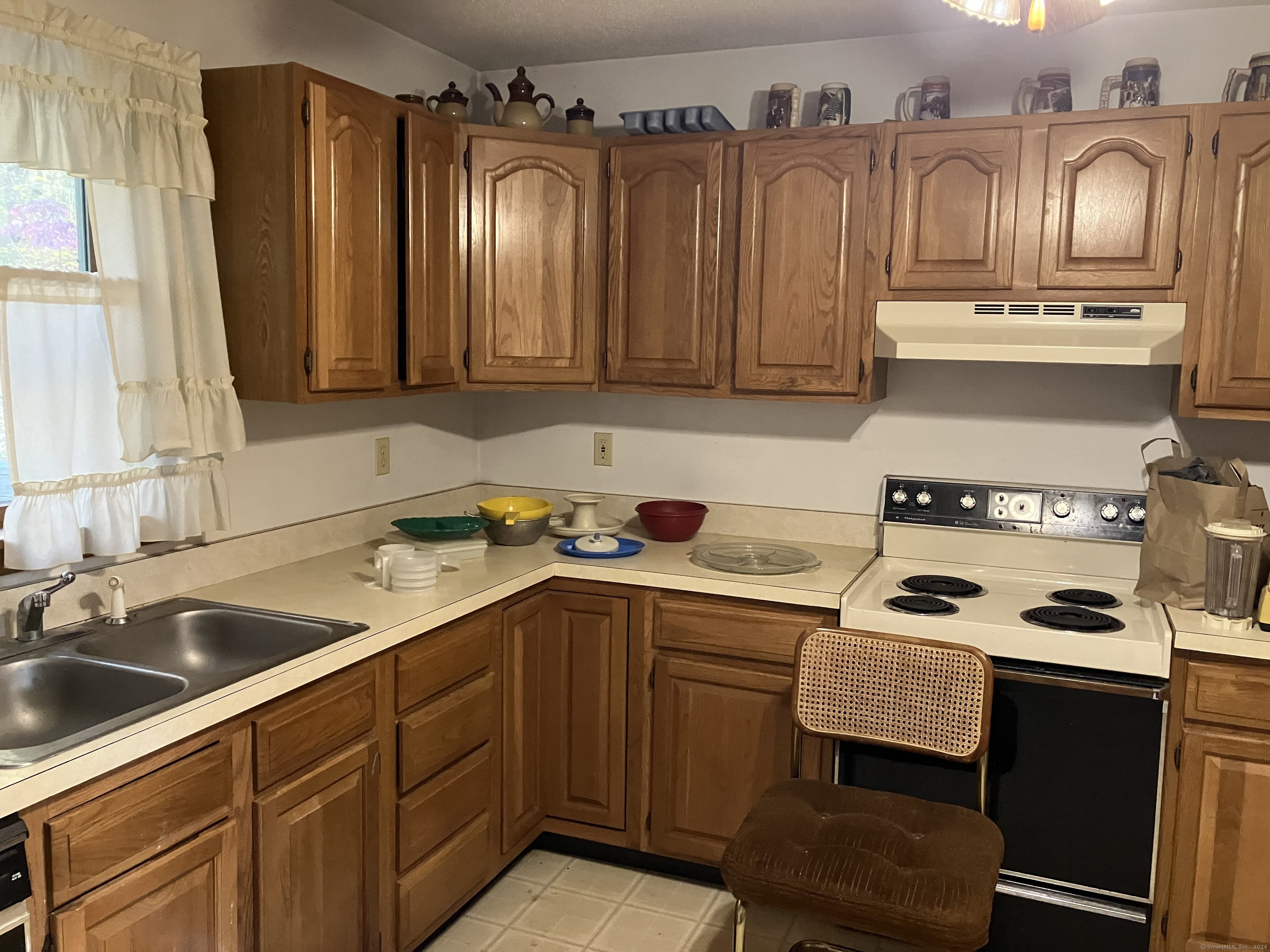 a kitchen with a sink cabinets and window