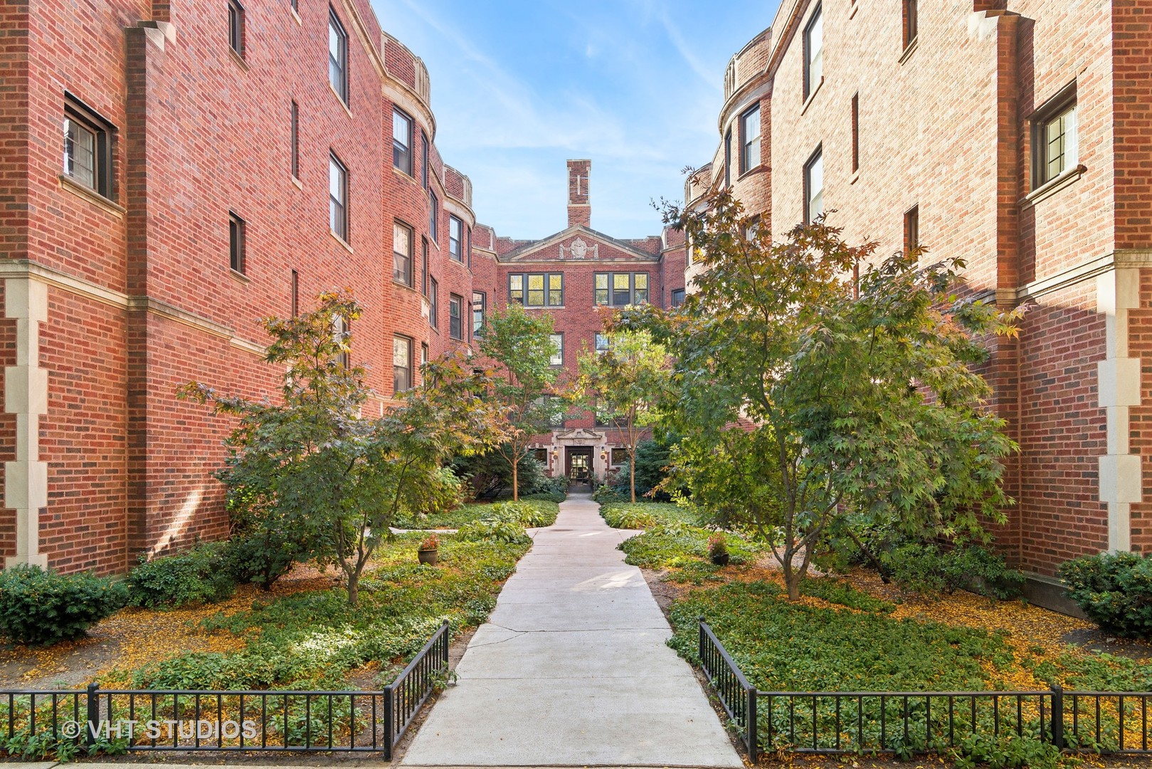 a front view of a multi story building with yard