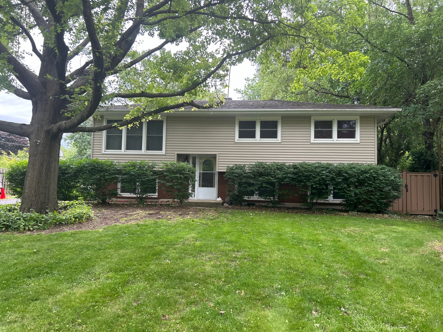 a view of a house with a yard and potted plants