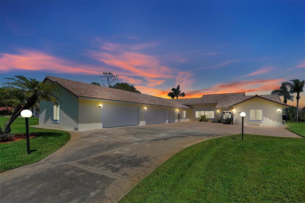 a front view of a house with a yard and a garage