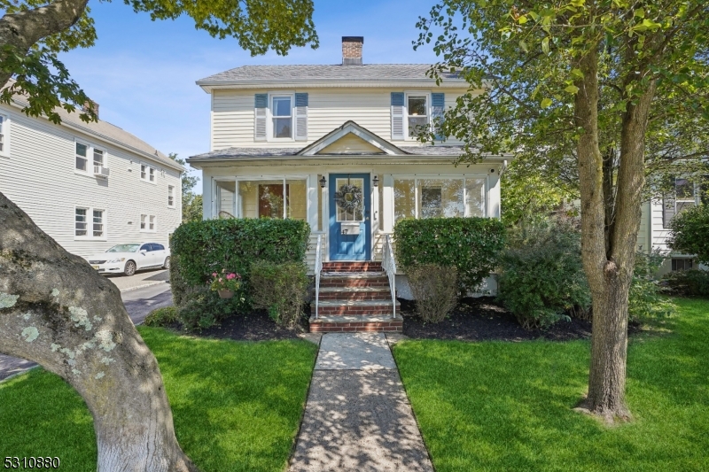 a front view of a house with a garden