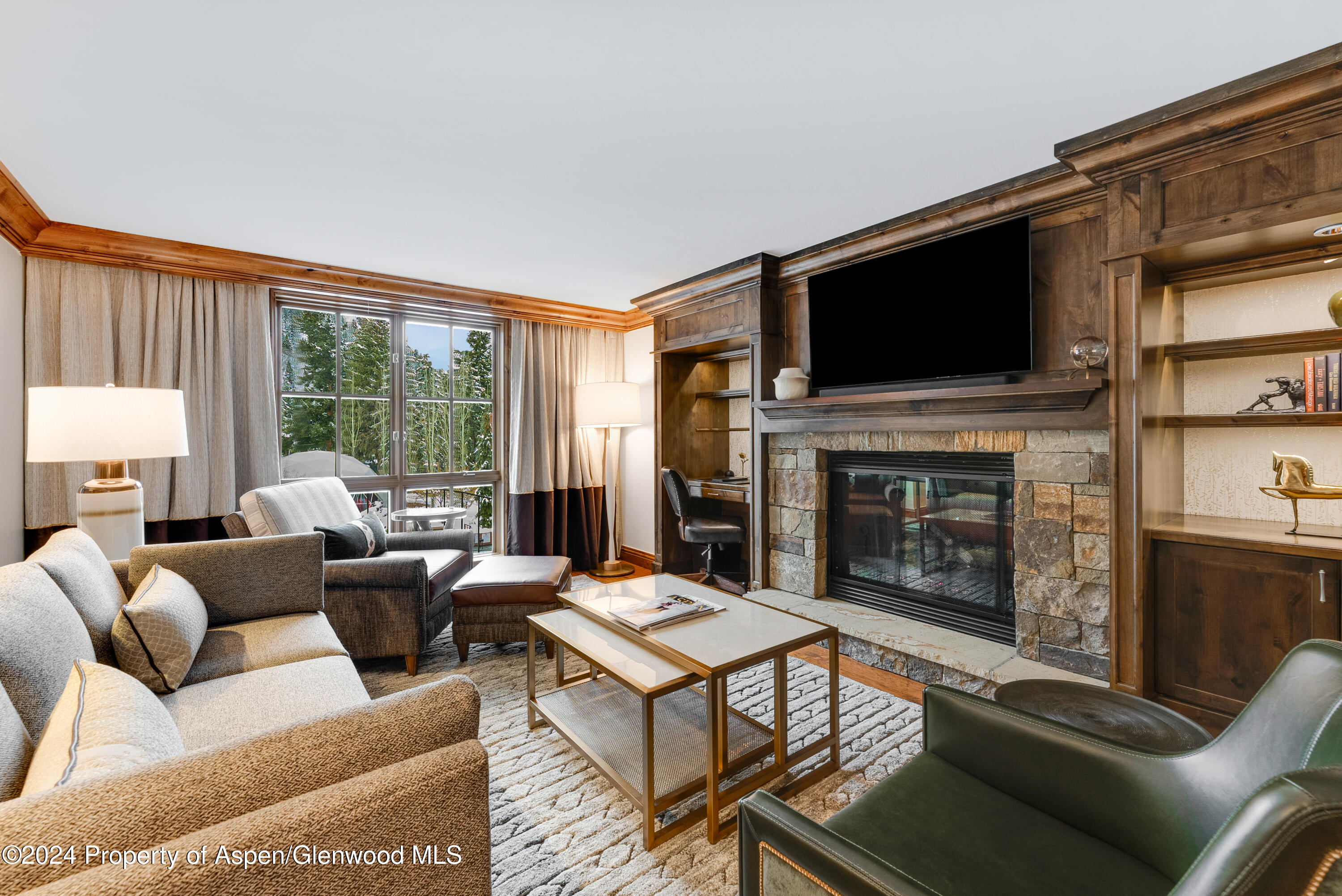 a living room with furniture a flat screen tv and a fireplace