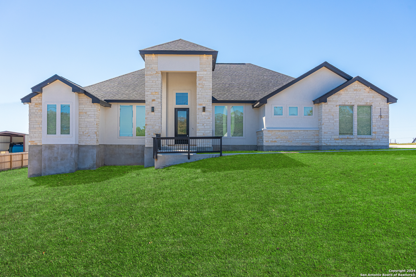 a front view of house with yard and green space