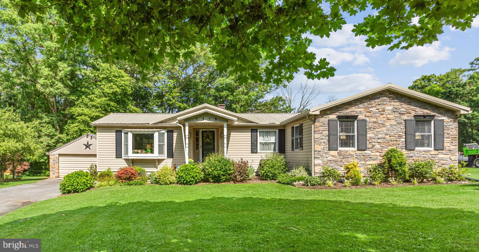 a front view of a house with a garden