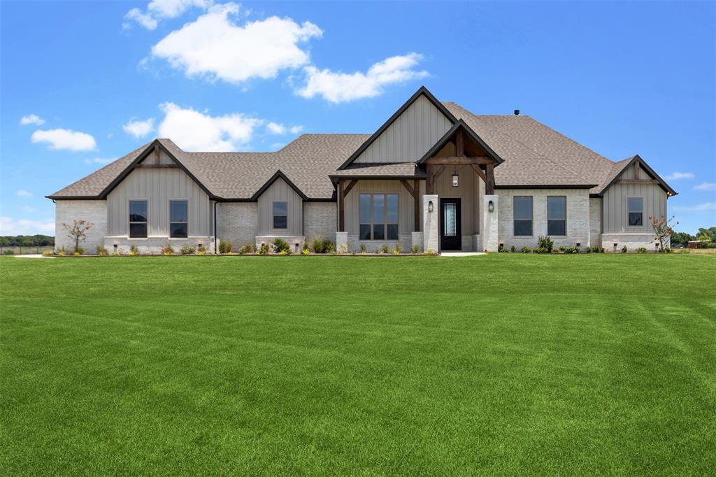 a front view of house with yard and green space