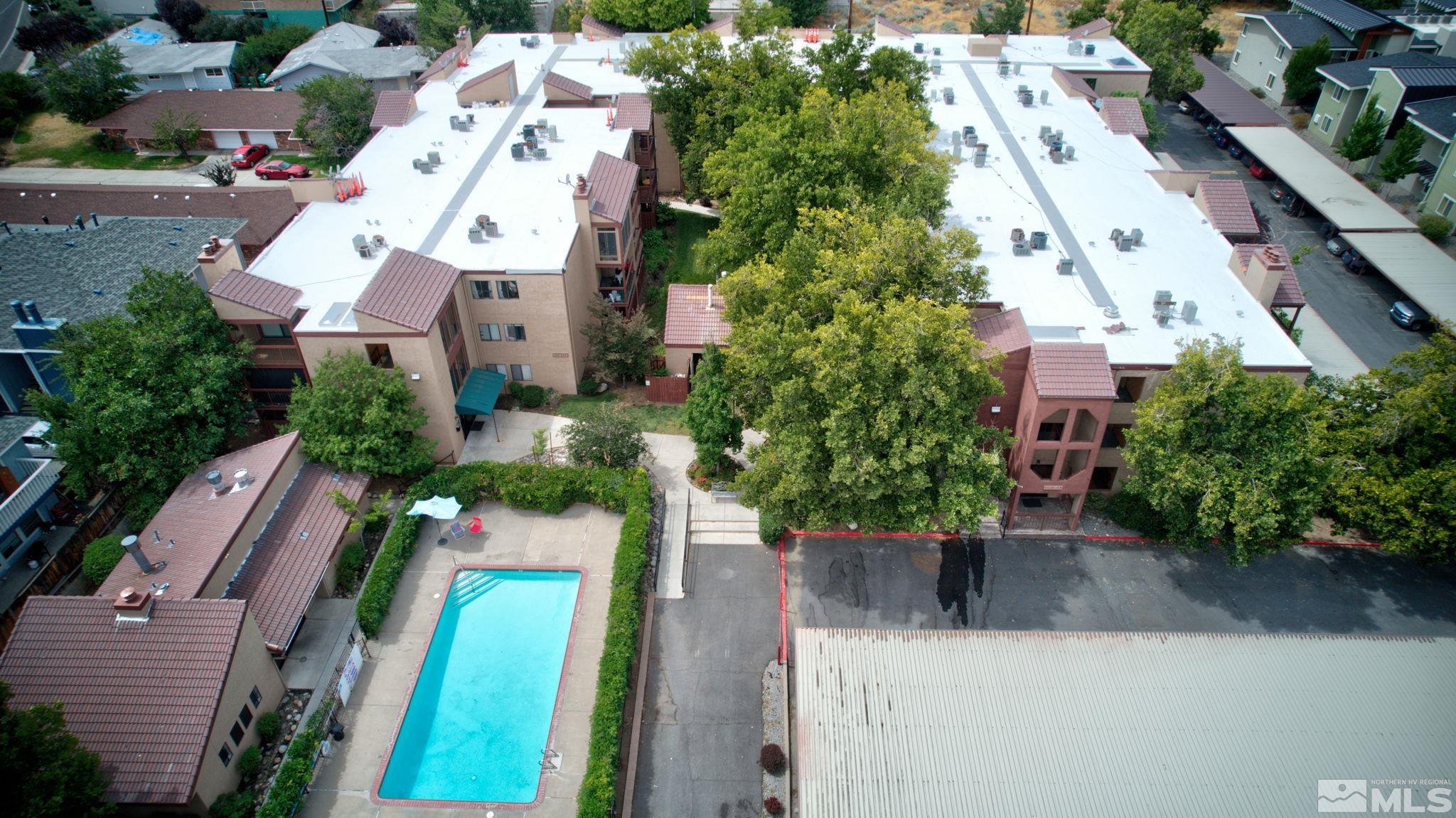 an aerial view of residential houses with outdoor space