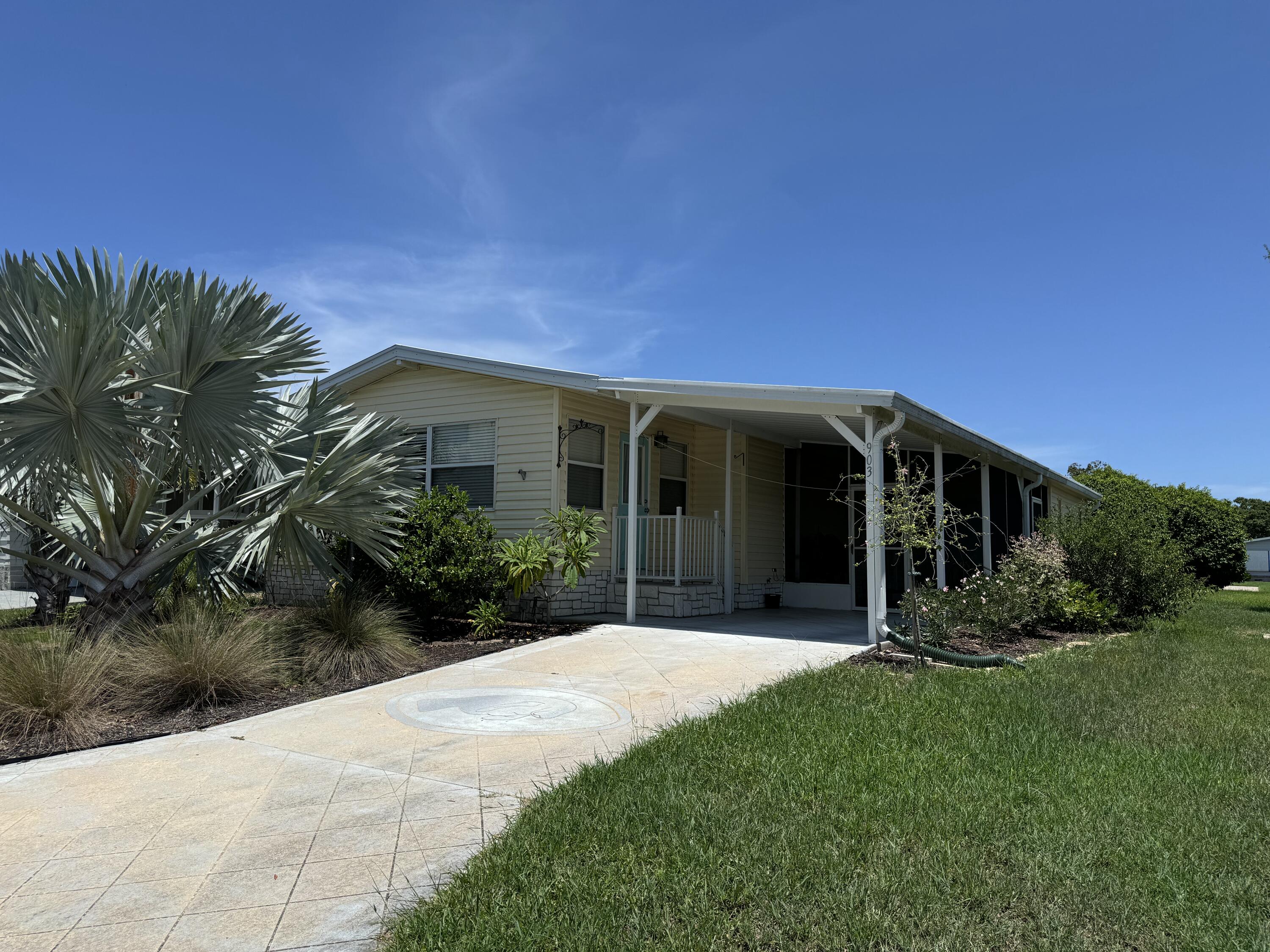 a view of a house with backyard and porch