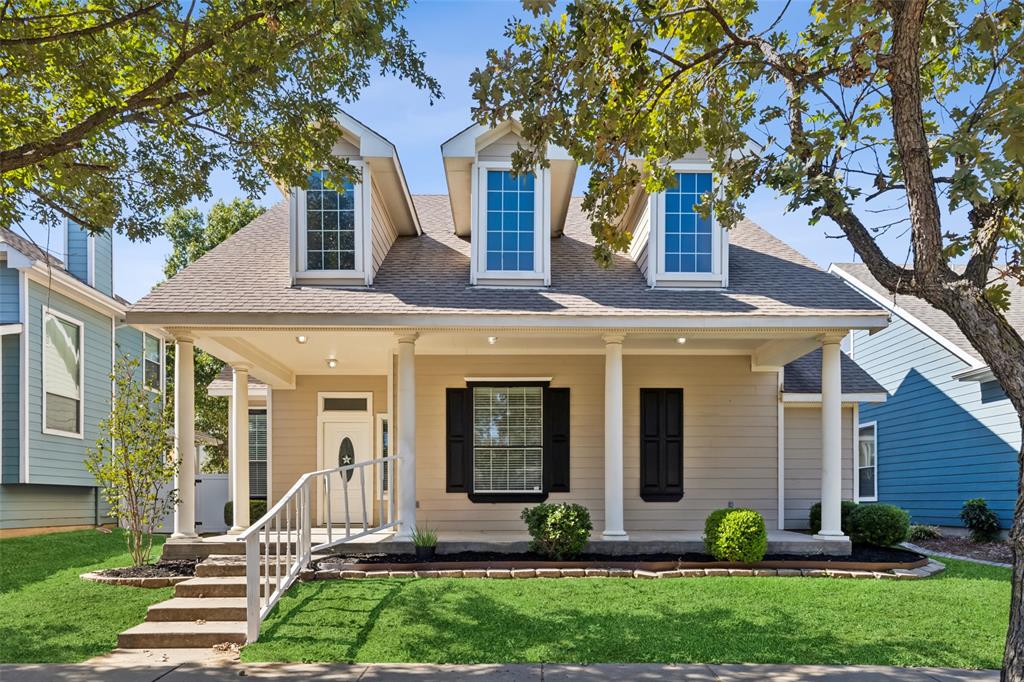 a front view of a house with a yard and plants