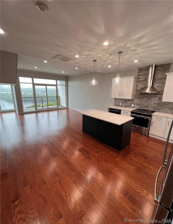 a view of an empty room with furniture and floor to ceiling window