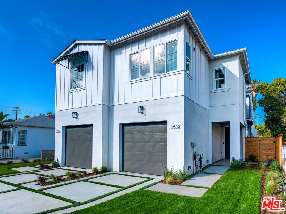 a front view of a house with yard and parking