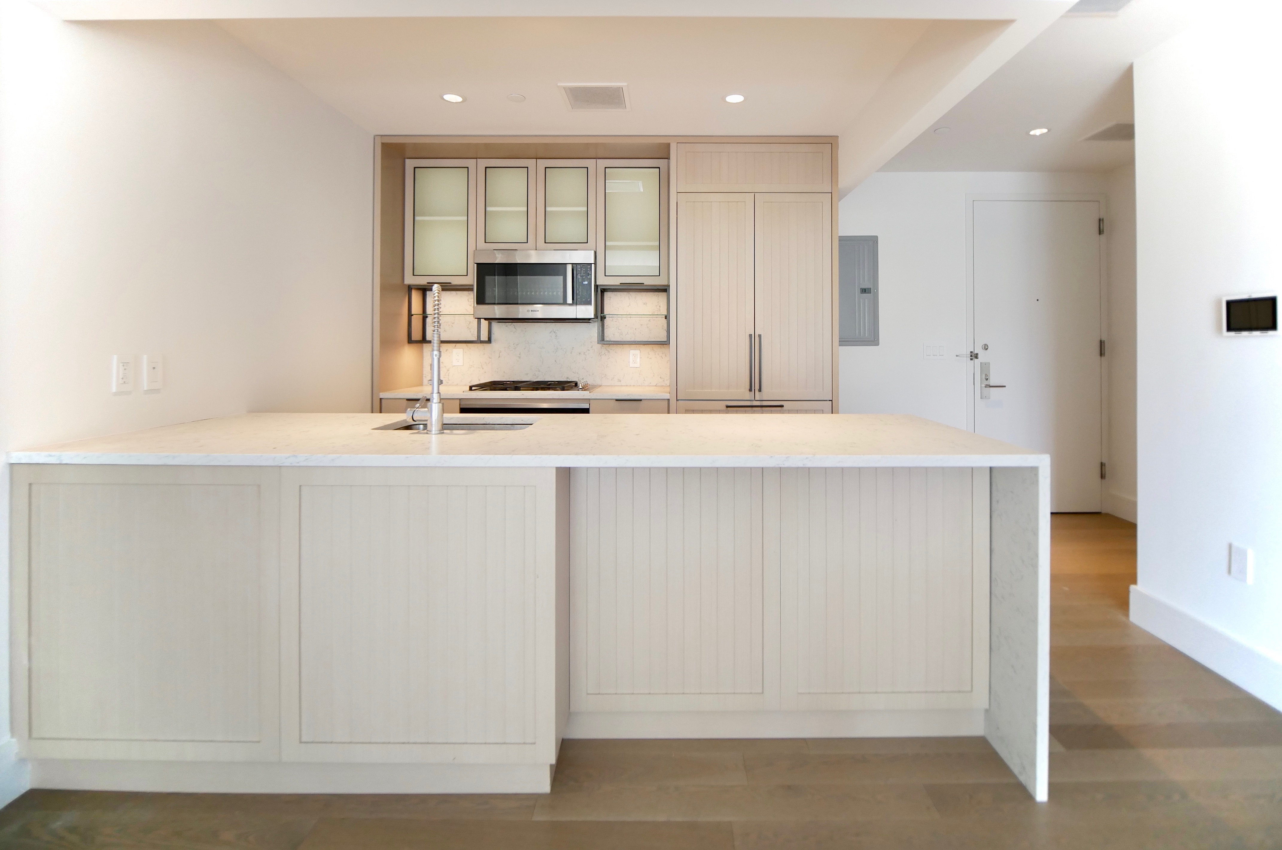 a kitchen with stainless steel appliances a refrigerator sink and stove