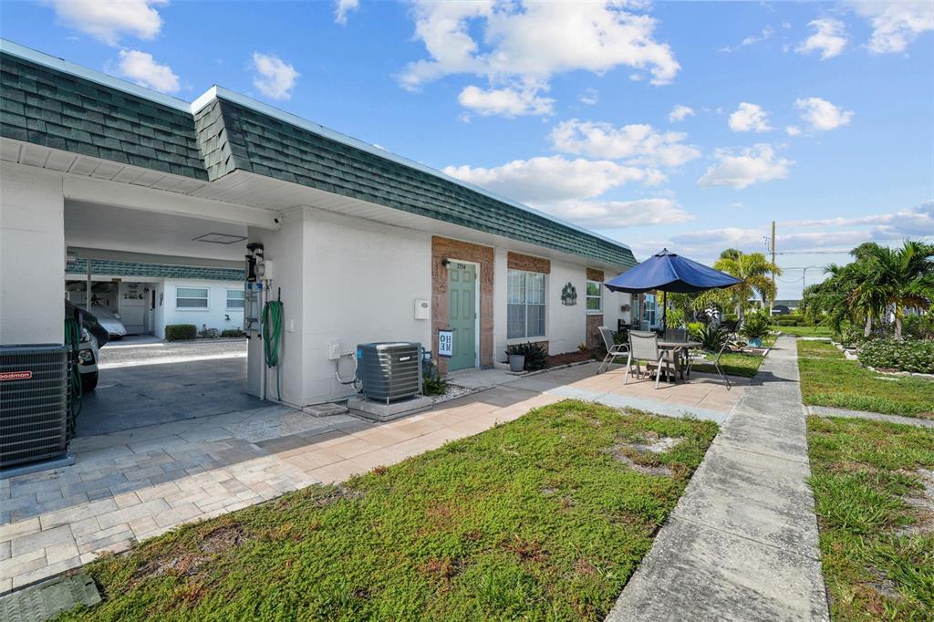 a view of a house with backyard porch and sitting area