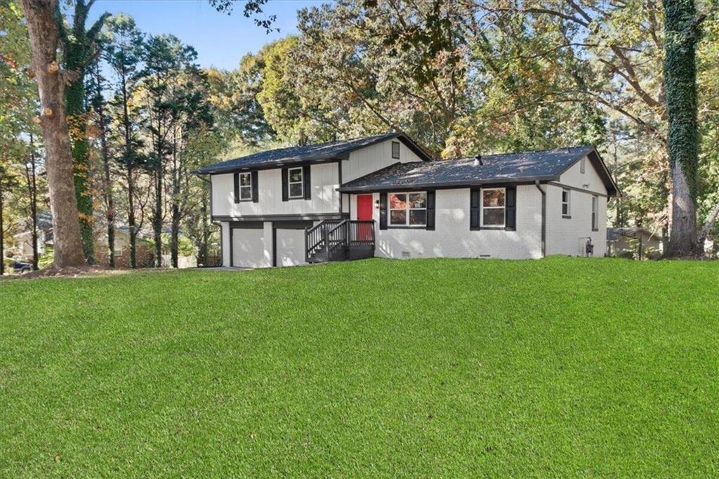 a front view of house with yard and green space