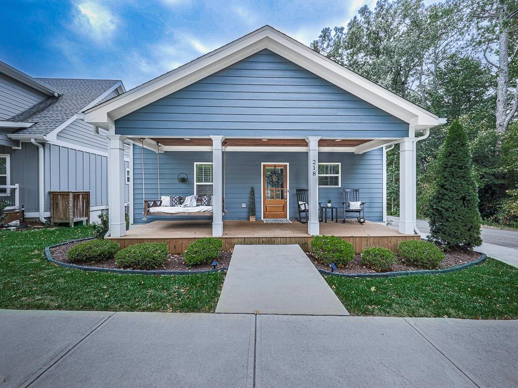 a front view of a house with a yard and porch