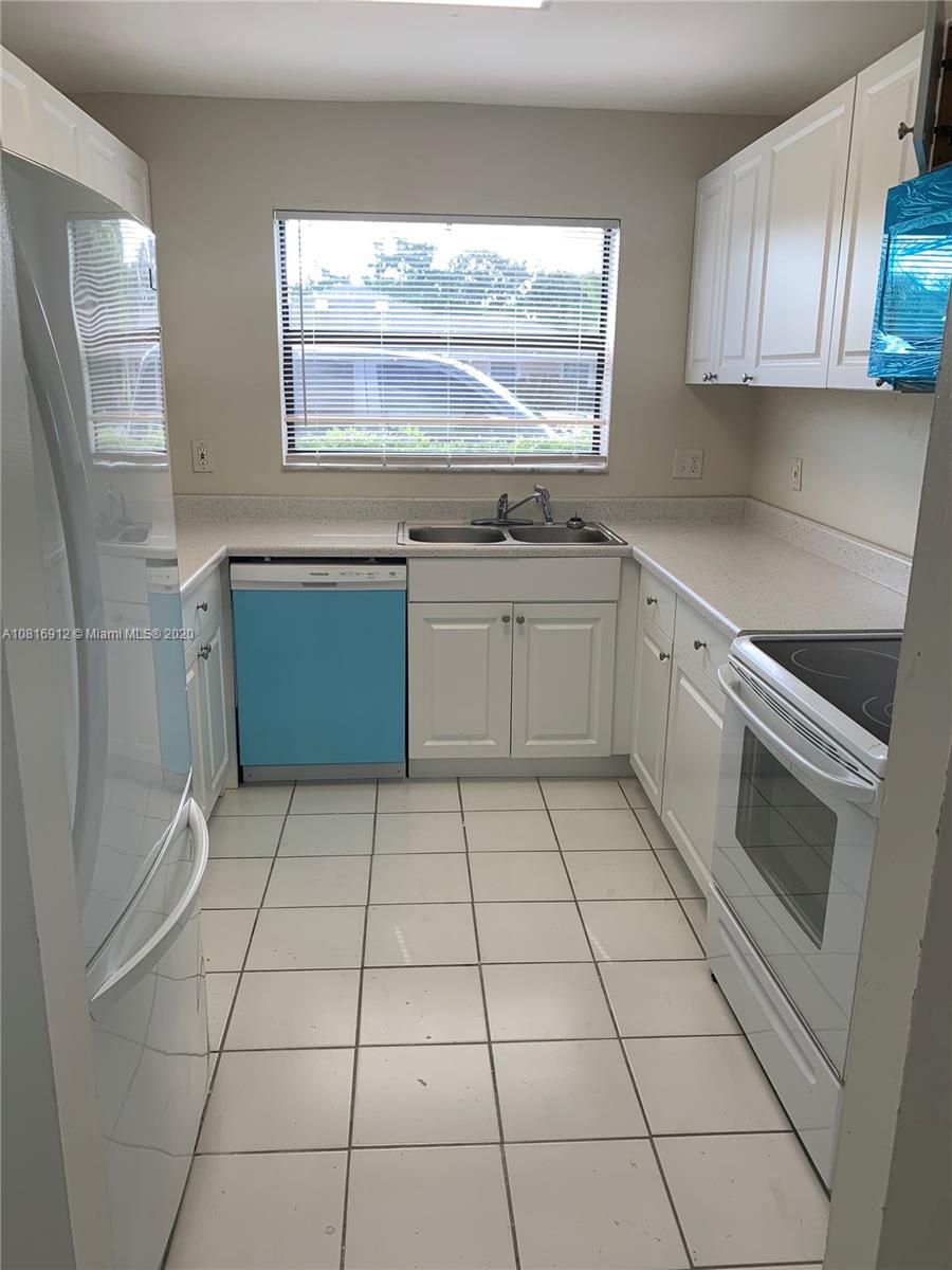 a kitchen with a cabinets a sink and a stove top oven