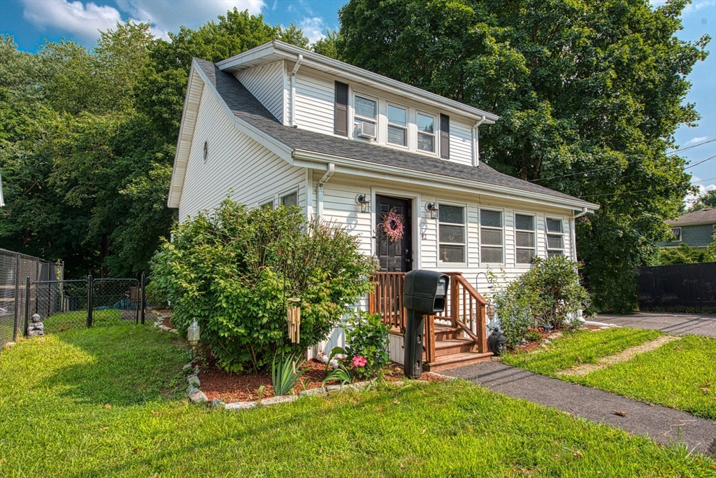 a front view of house with yard and green space