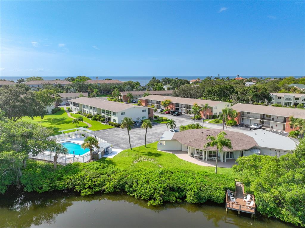 an aerial view of a house with a garden and lake view