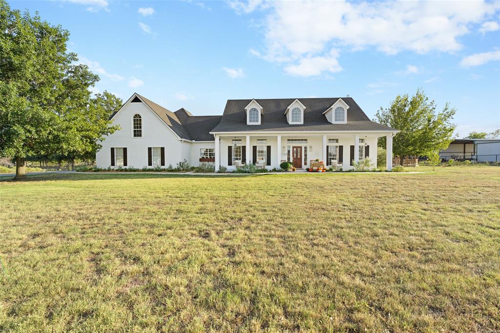 a front view of a house with a big yard