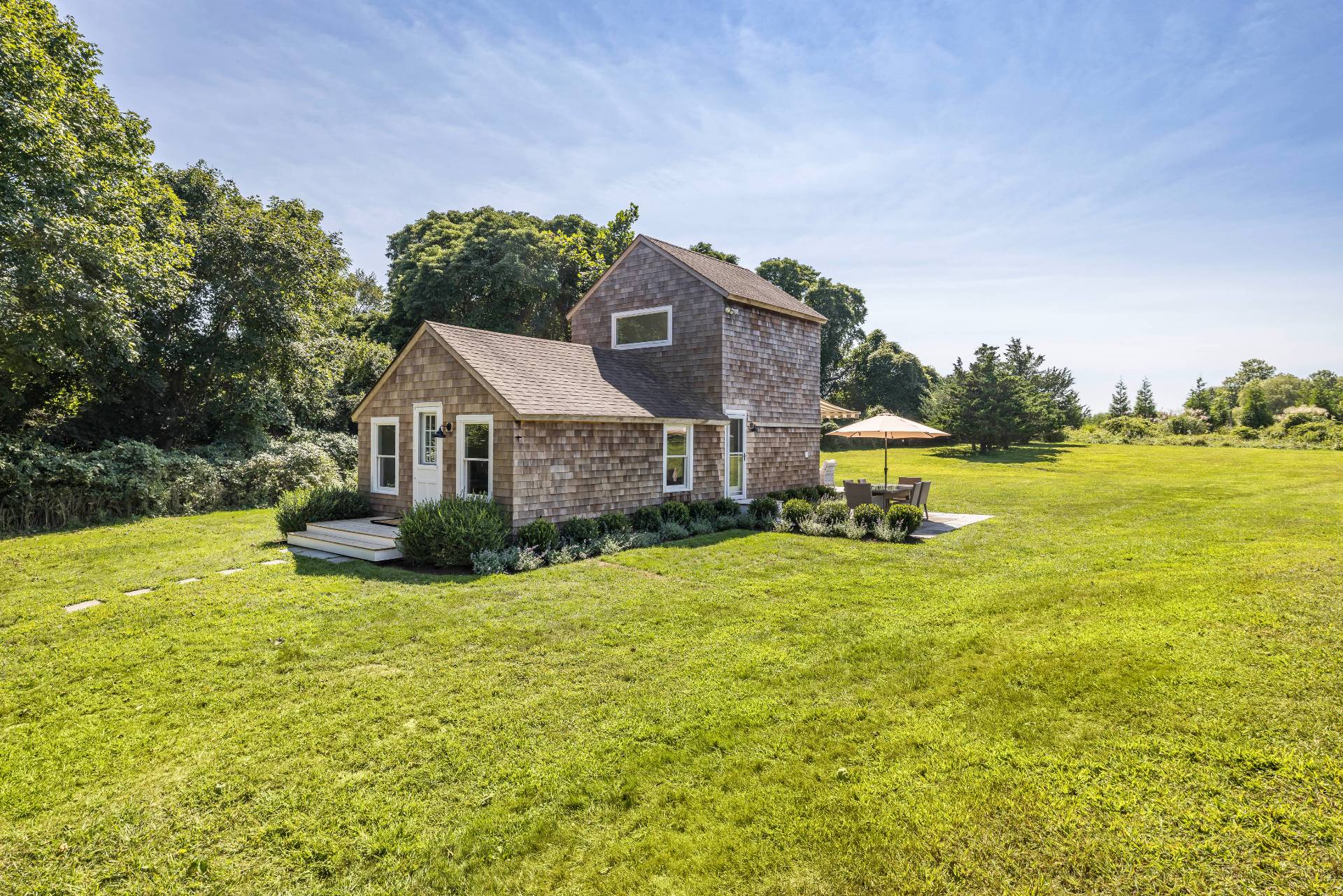 a front view of a house with a big yard