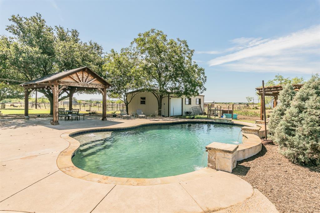 a view of a house with swimming pool and sitting area