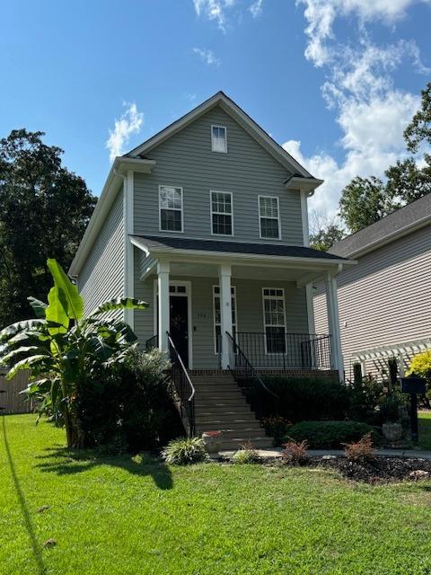 a front view of a house with a yard and outdoor seating