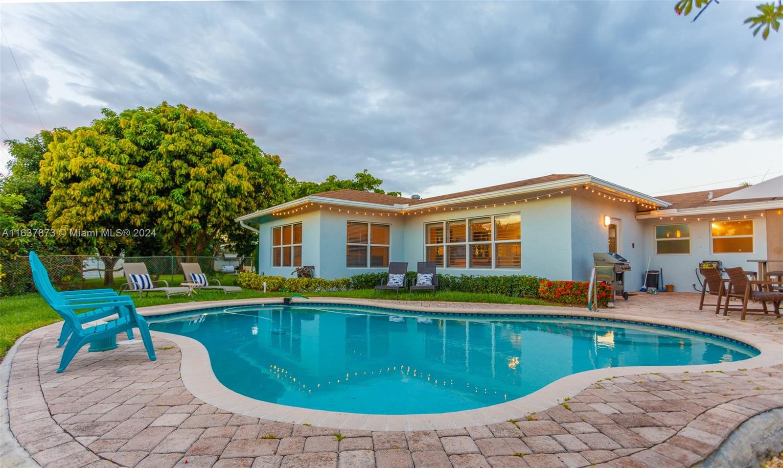 a view of a house with swimming pool and a yard