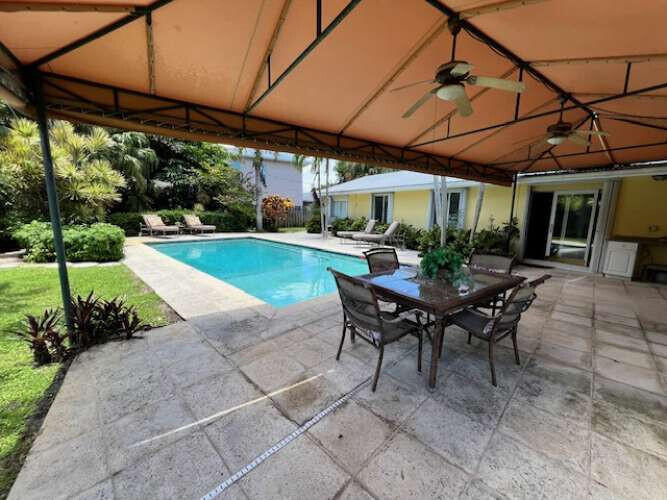 a view of a backyard with sitting area and furniture