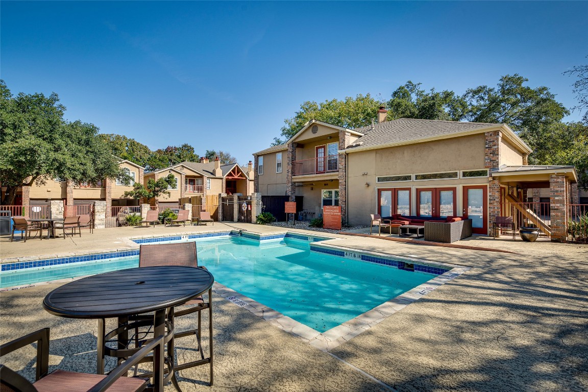 a view of a house with swimming pool and sitting area