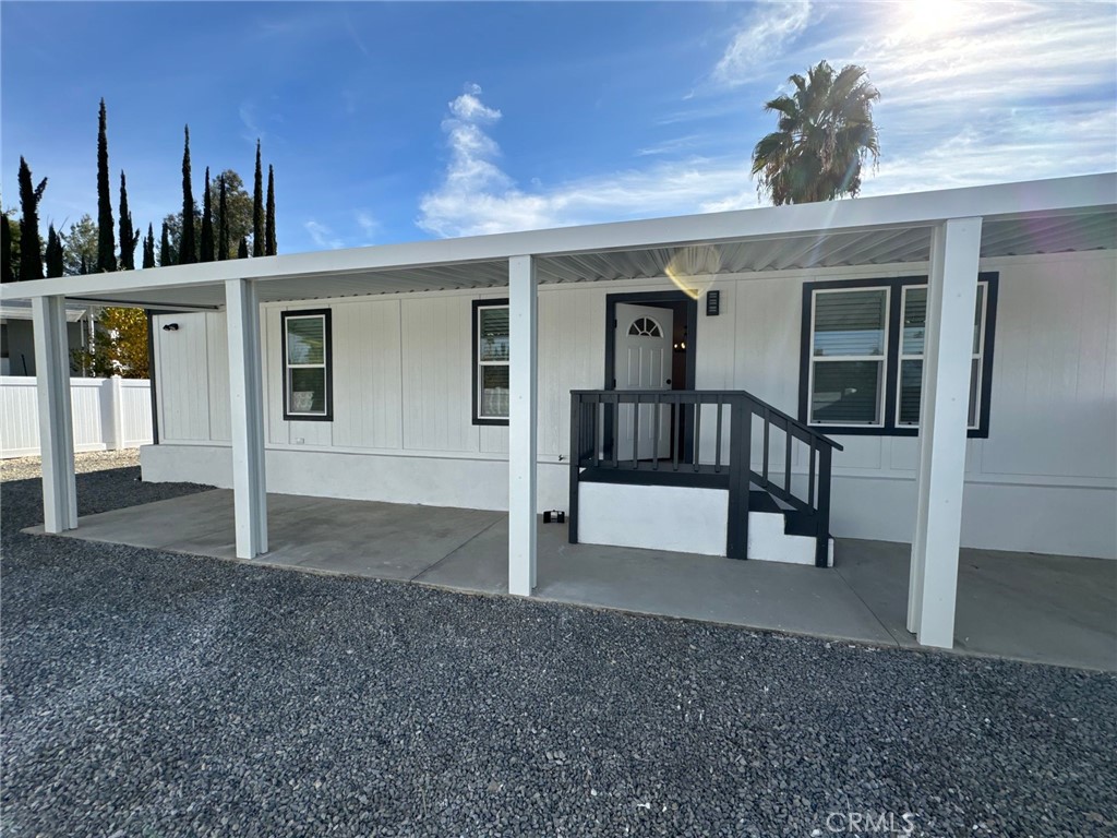 a view of a house with porch and furniture