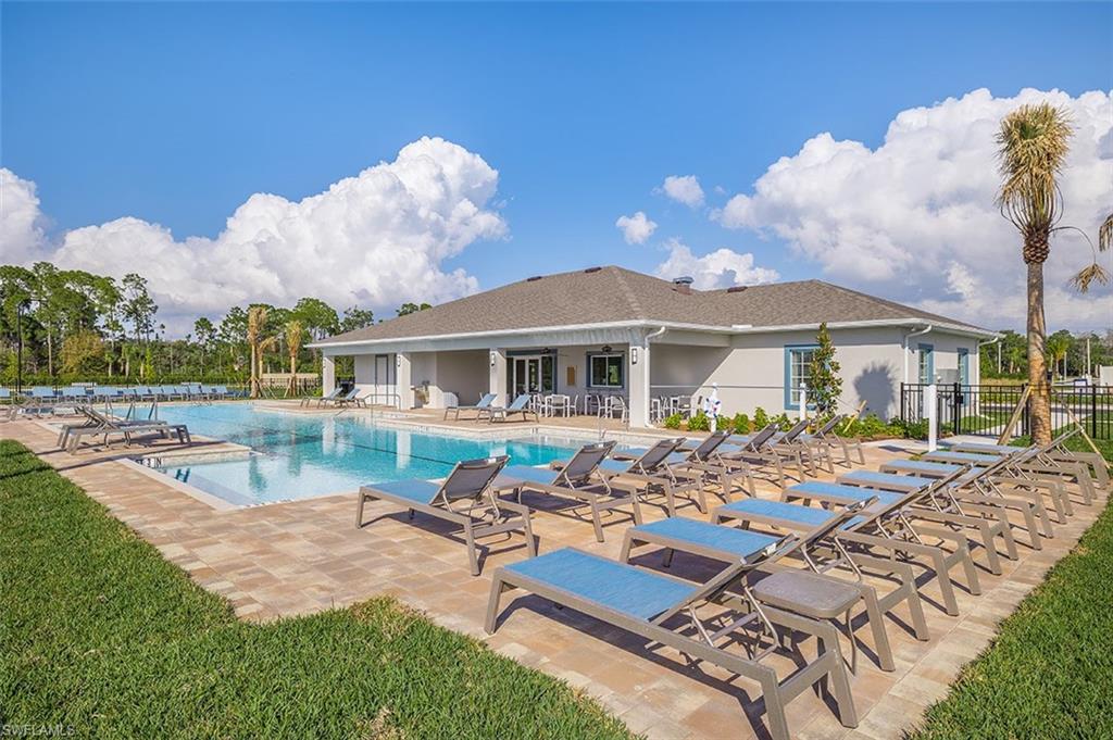 a view of a house with swimming pool and sitting area