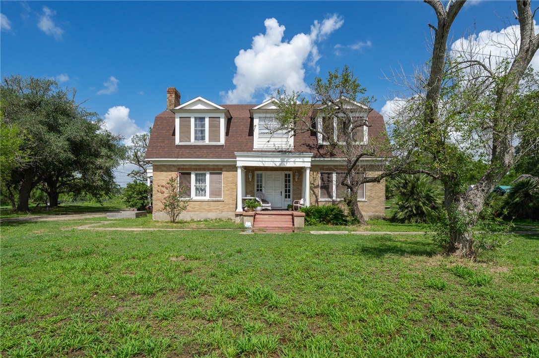 a view of a house with a yard porch and furniture