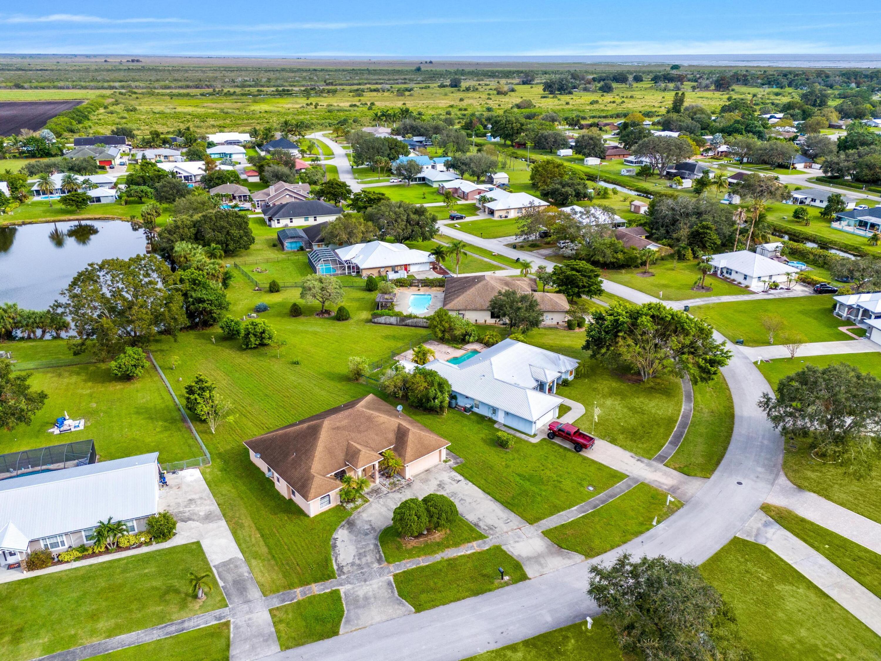 an aerial view of residential houses with outdoor space and swimming pool