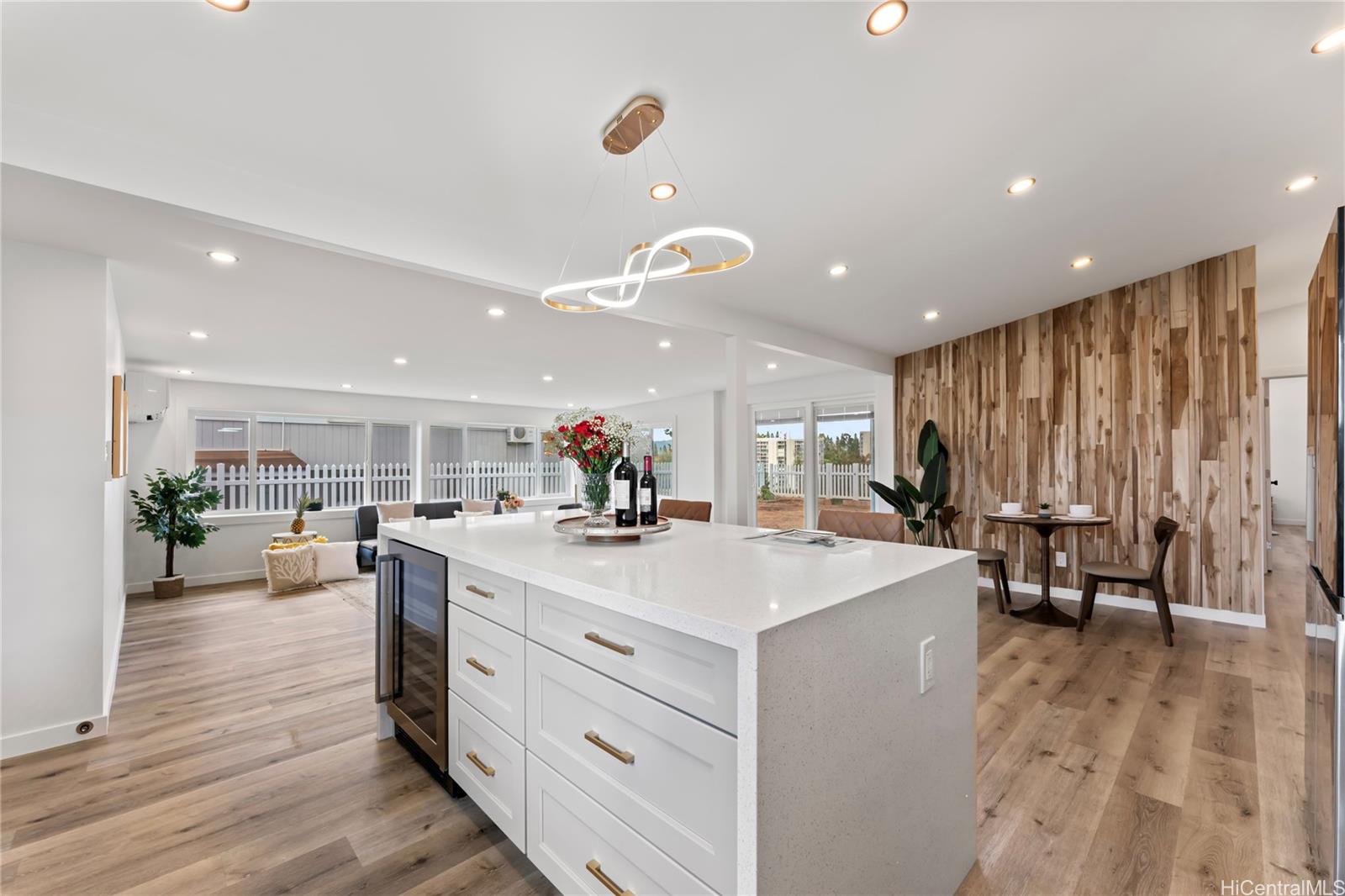 a large kitchen with kitchen island a sink table and chairs