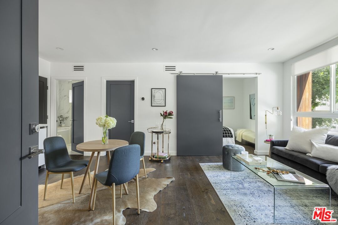 a living room with furniture and wooden floor