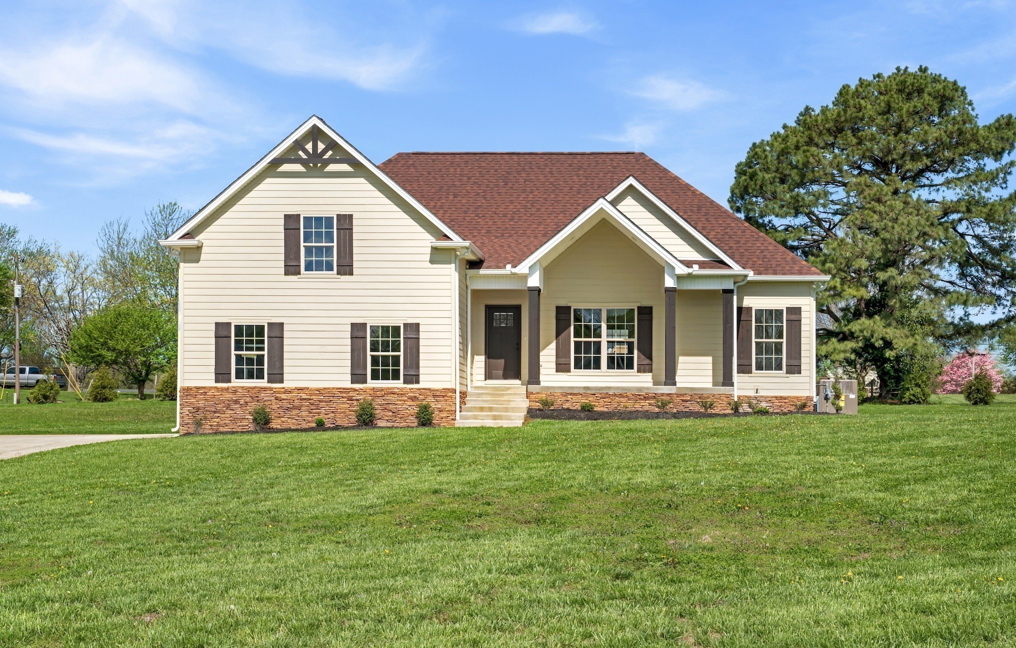 a front view of house with yard and green space