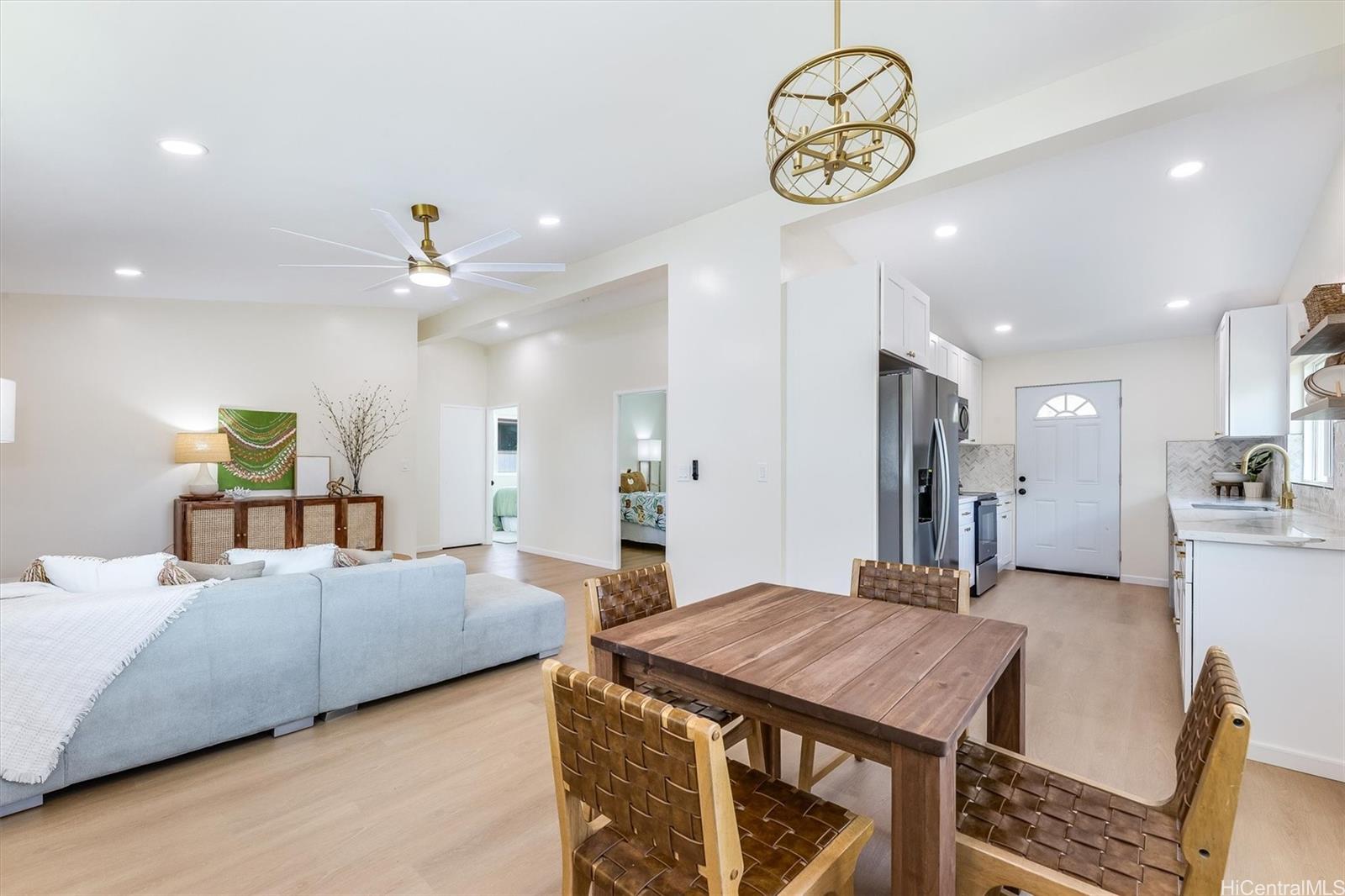 a living room with a couch and chandelier