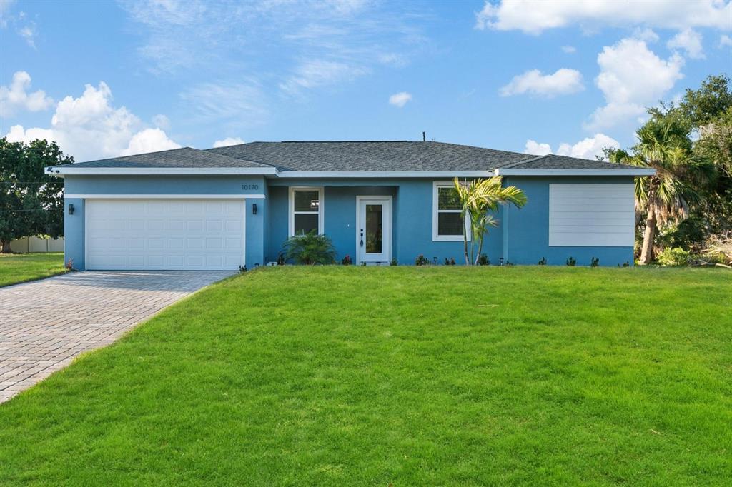 a front view of house with yard and trees