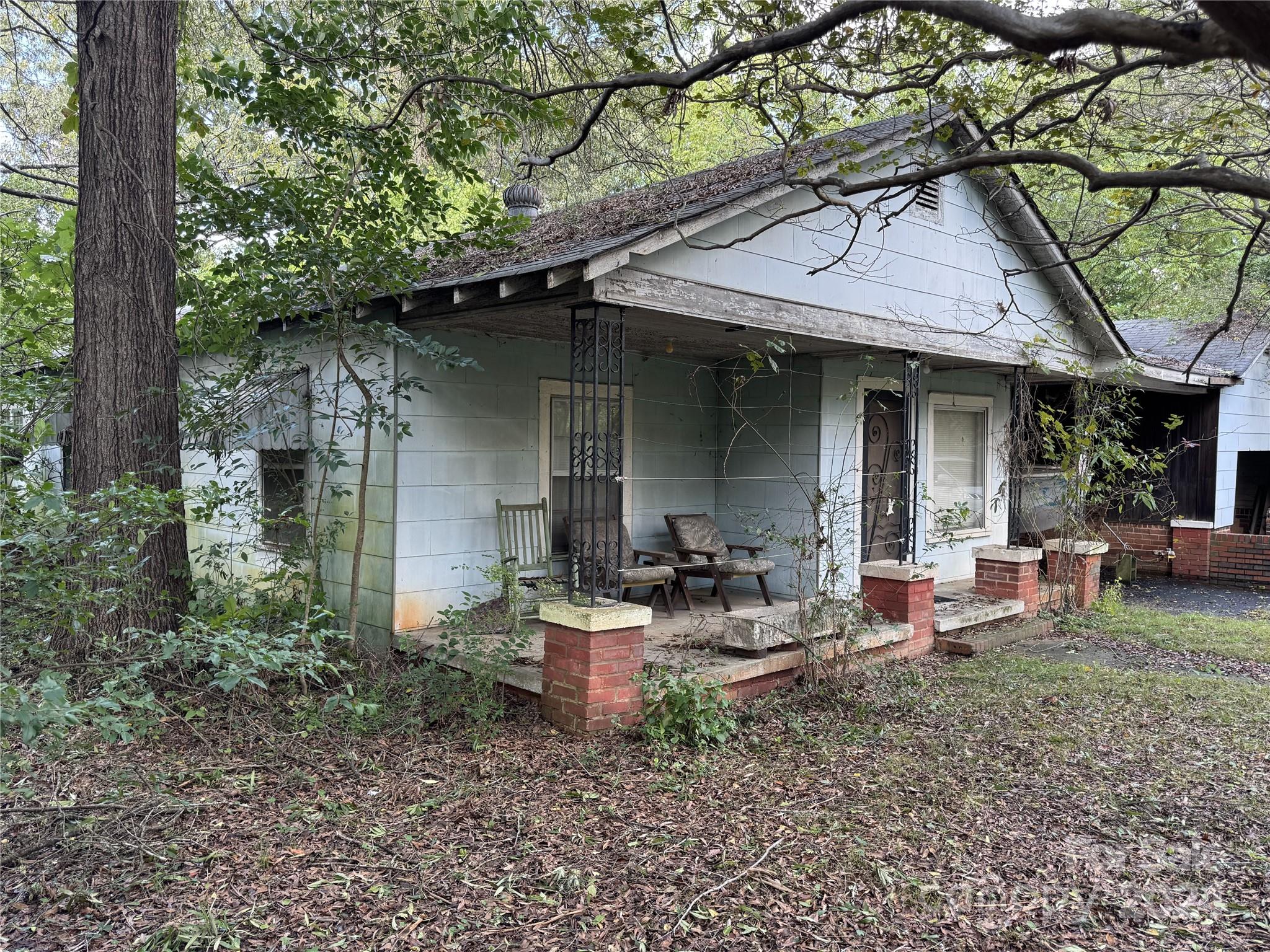 a view of a house with backyard sitting area and garden