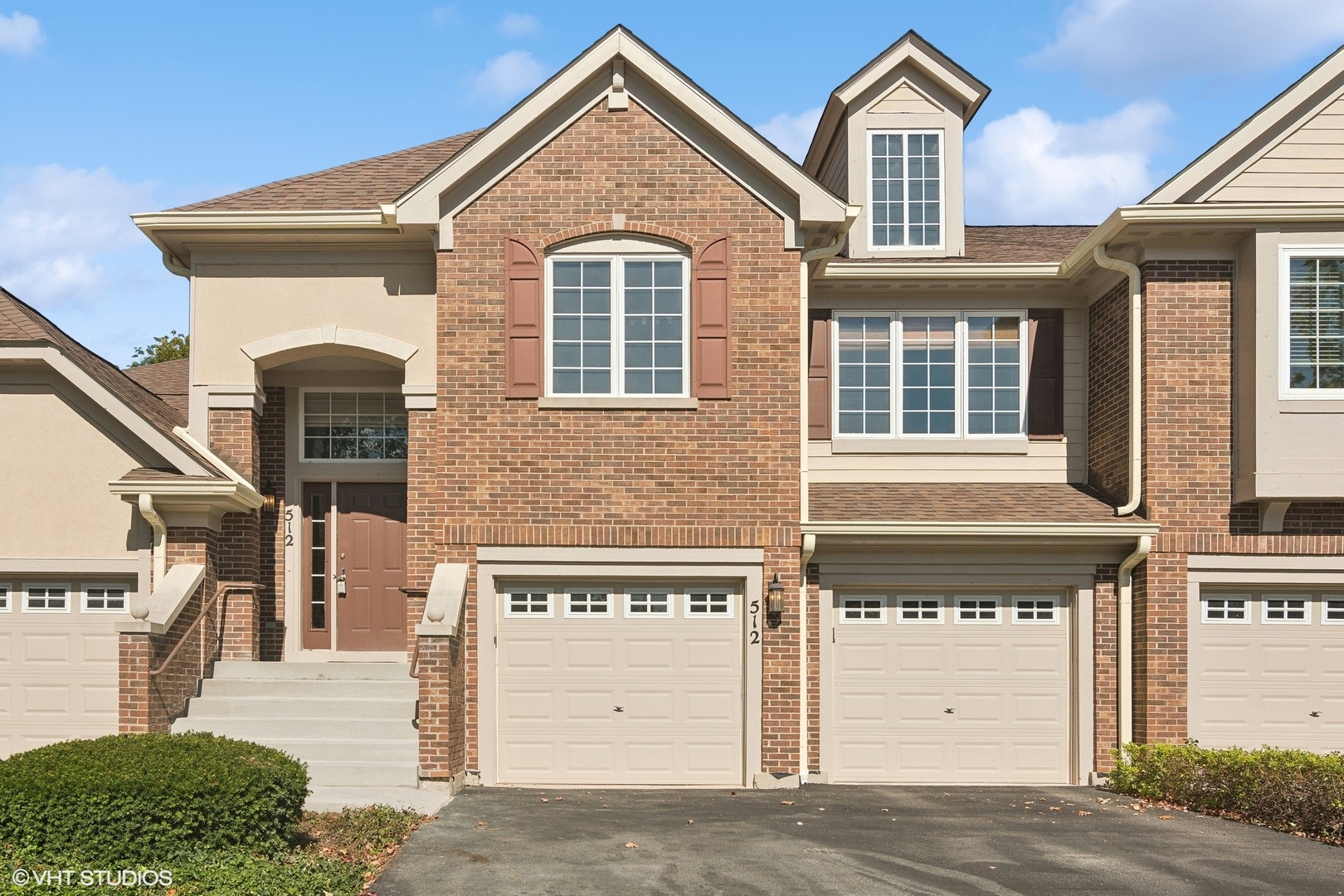 a front view of a house with a parking area