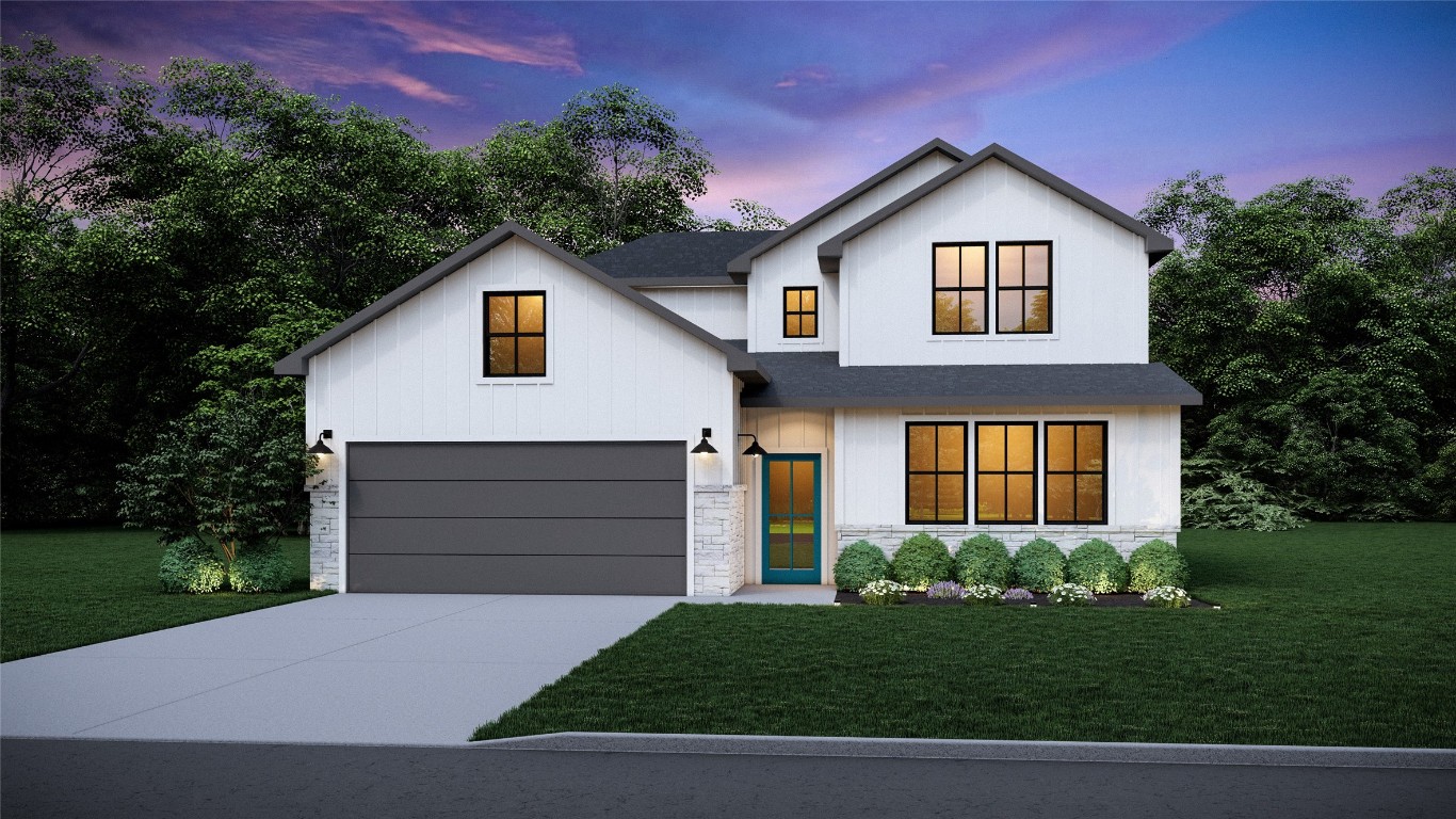 a front view of a house with a yard and garage