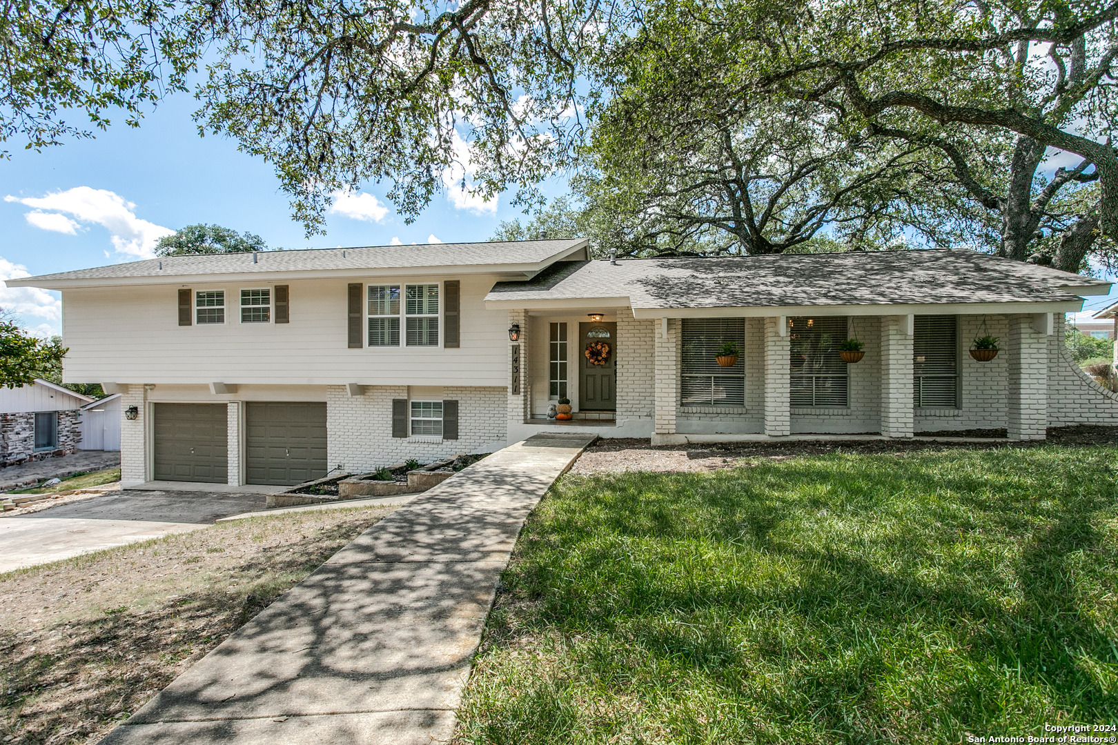 a front view of a house with a garden