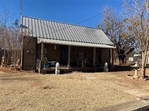 a view of a house with a patio outdoor space and a yard