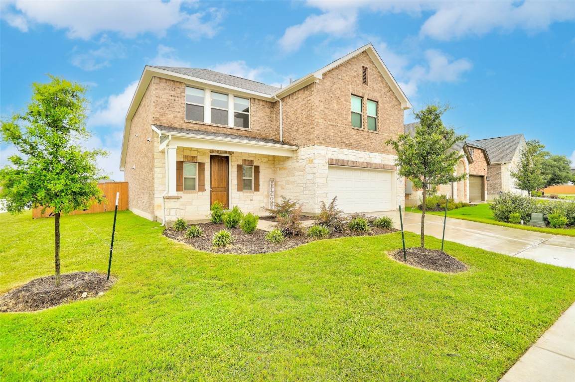 a front view of a house with a yard